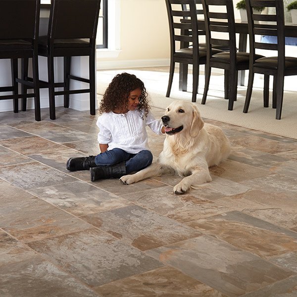 Girl and dog sitting on a durable tile floor