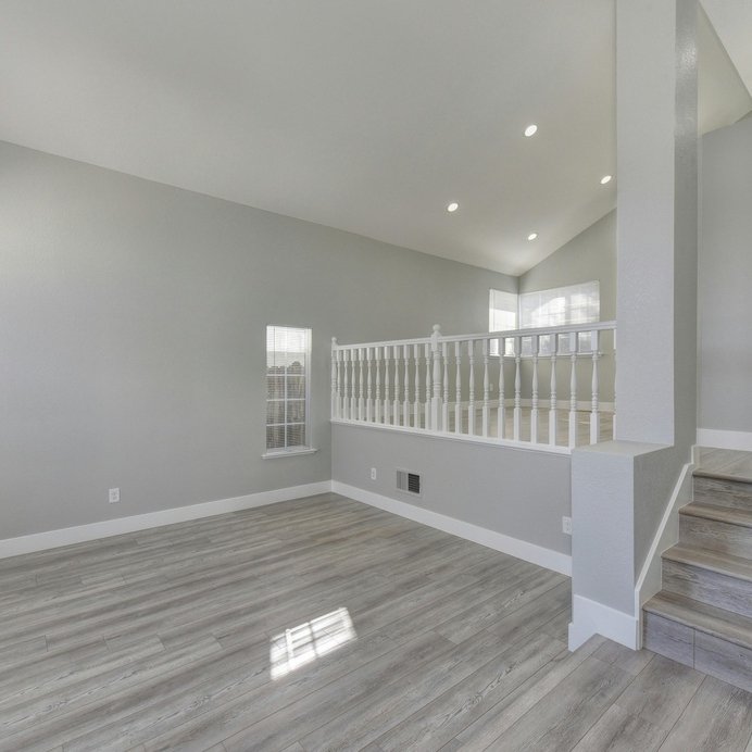 Open concept home with grey LVP floor