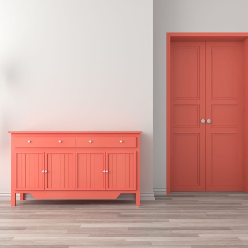 Minimalist room with coral colored accents